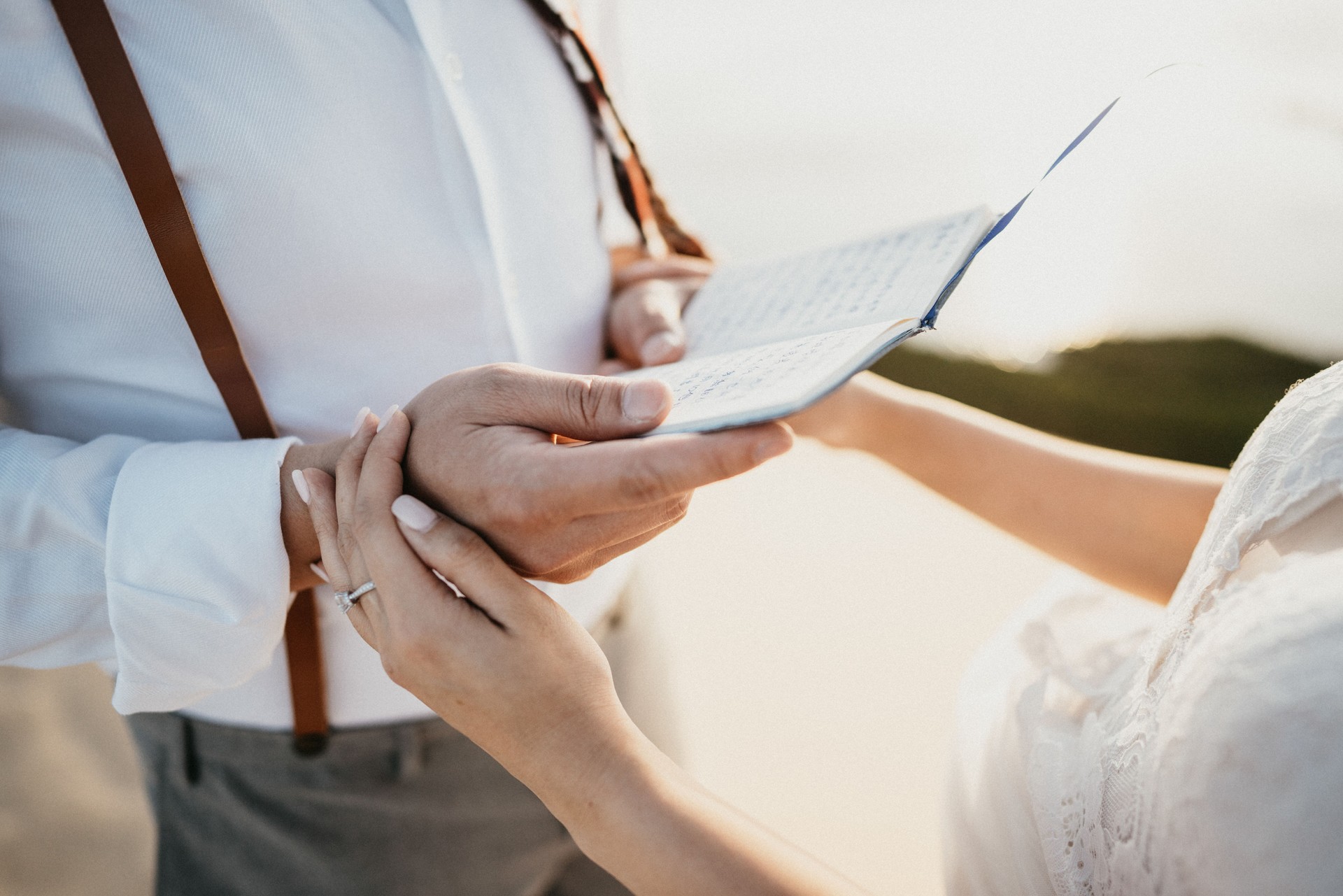 Asian Bride and groom, desert elopement, holding hands, reading the love letter