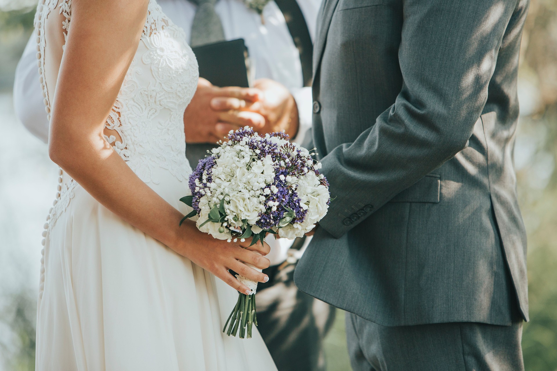 Bride and Groom Saying Vows during Wedding Ceremony Outdoors